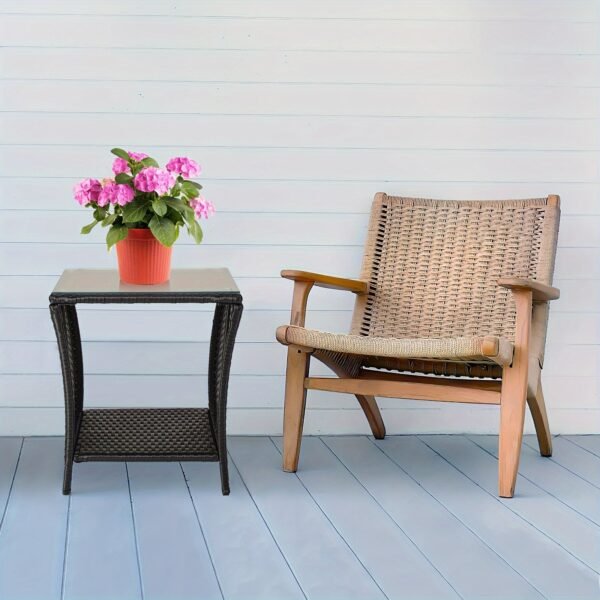 "A black four-line rattan double-layered side table with glass top, suitable for small living rooms in households